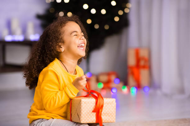 A Girl Laughing with Christmas Gift